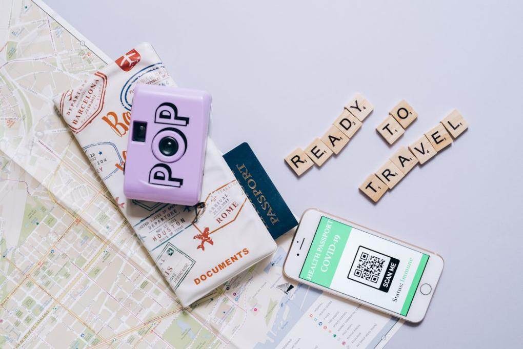 A close-up shot of Scrabble tiles near a cellphone, symbolizing the importance of staying organized and connected during the emergency passport application process.